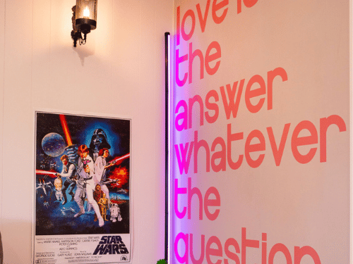 Sign on wall that reads 'love is the answer whatever the question'