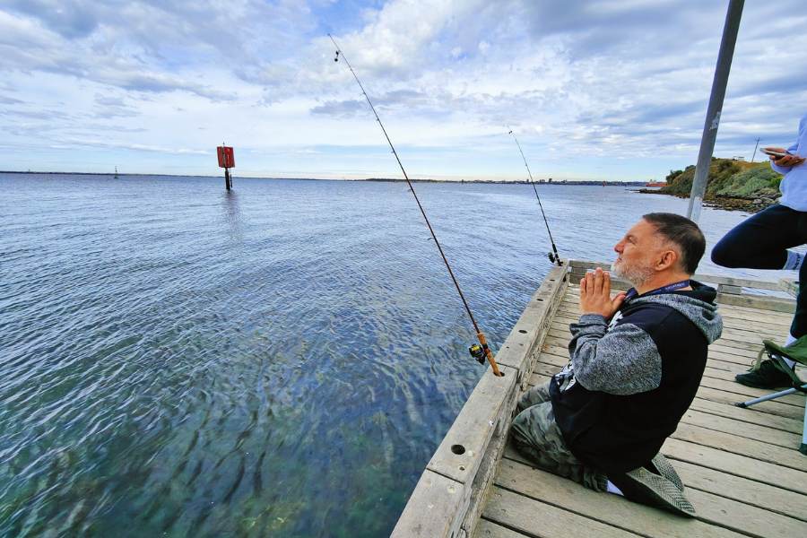 NDIS participant fishing on pier