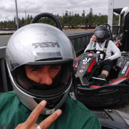 A man and a woman riding go karts