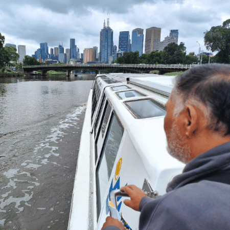 A man riding a boat looking at the scenery