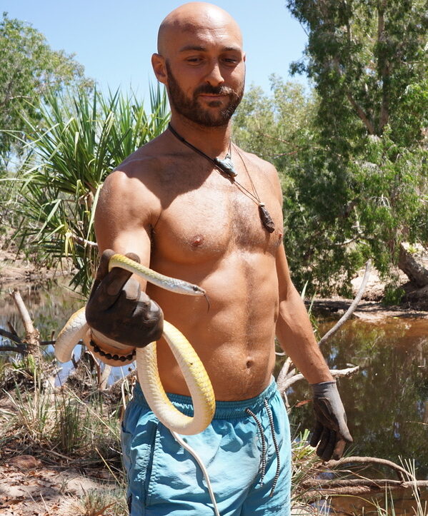 A man holding a snake