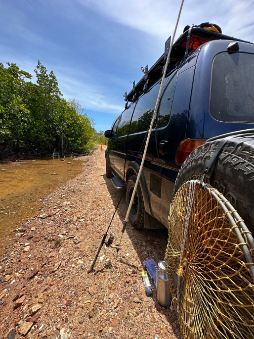 Close up of a car with fishing rods leaning against it