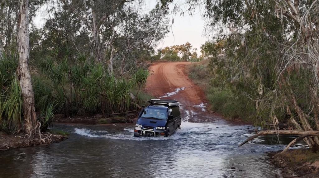 A van driving through water