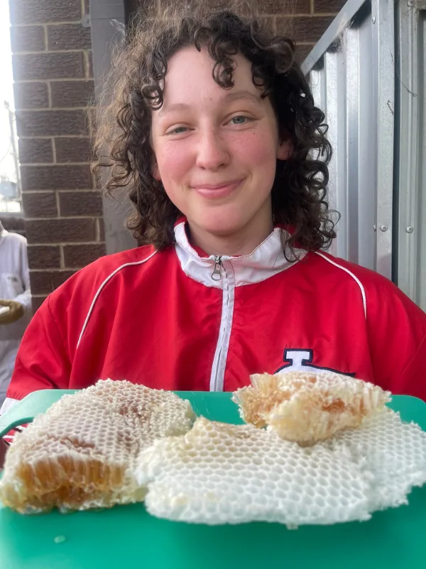 Woman smiling with honeycomb