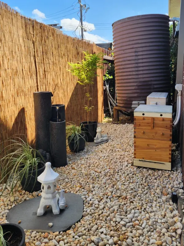 Outdoor area in backyard with statues and bee hive