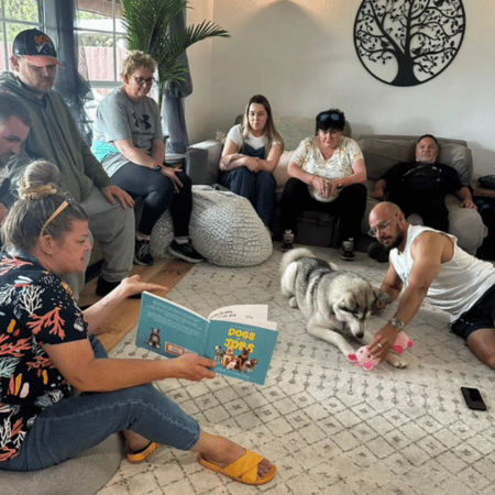 Group of people in the living room with a dog