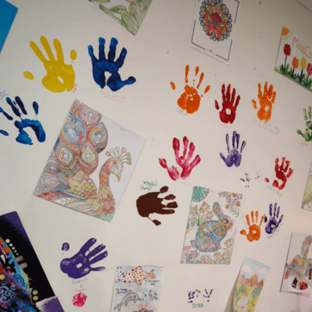 A wall with hand art