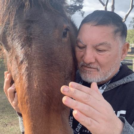 A man hugging a horse