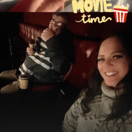 A man and a woman watching movies